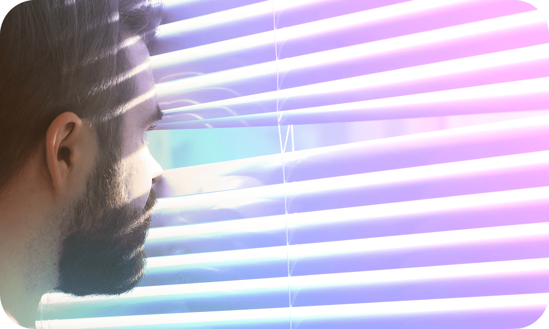 Picture of a man looking out between blinds
