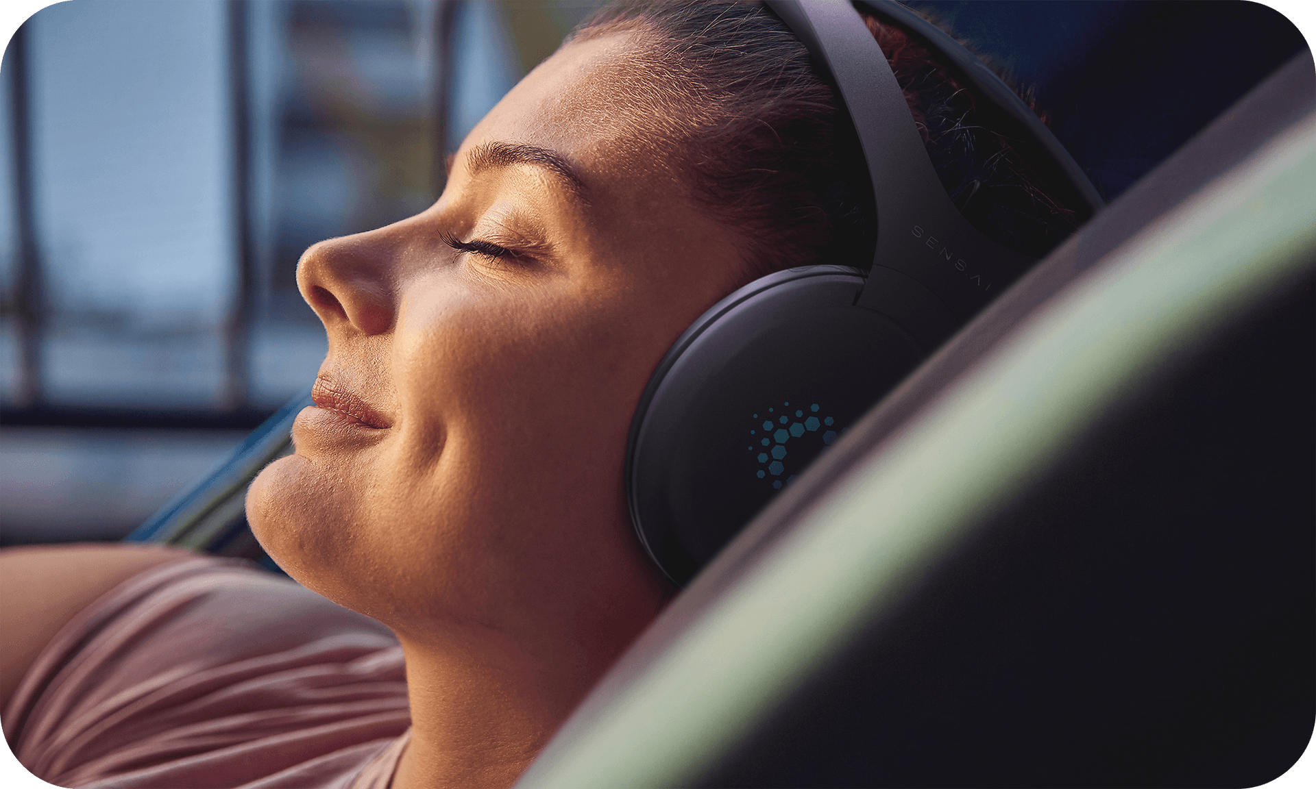 Women meditating wearing the Sens.ai headset looking very peaceful and serene