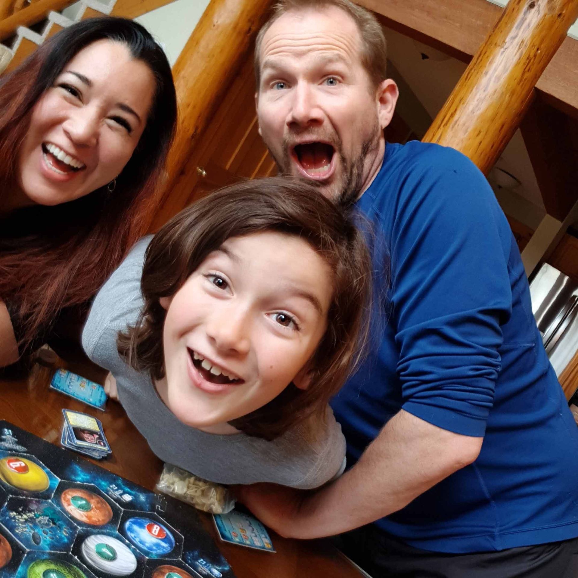 A photo of the Telfer family having fun playing Catan